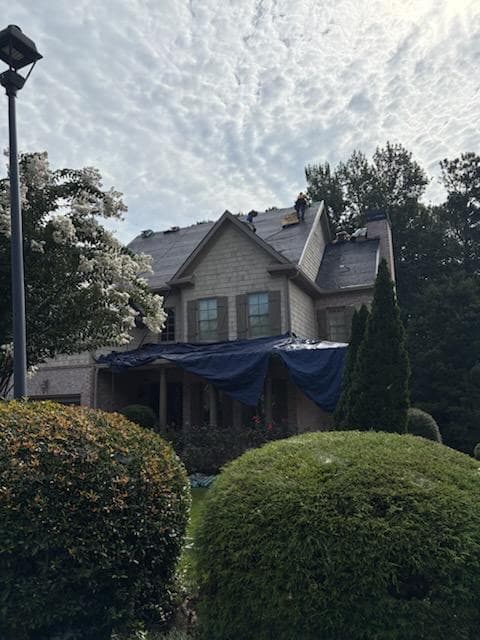 A Buford-area home tarped by Bailey after storm damage to the roof